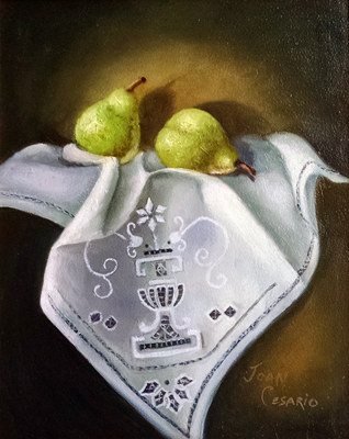 Pears on a white linen tablecloth.